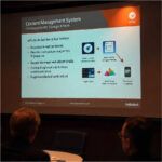 Team managing digital content on multiple devices including laptop and tablet